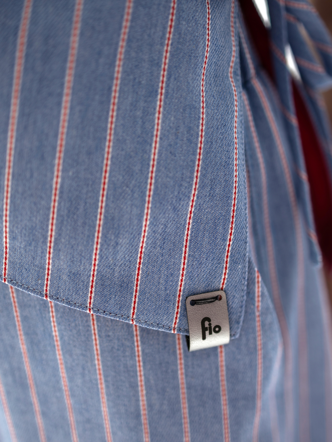 Dwustronna kamizelka Lucia bez rękawów, czerwona z jednej strony i w jasnoniebieski prążek z drugiej.